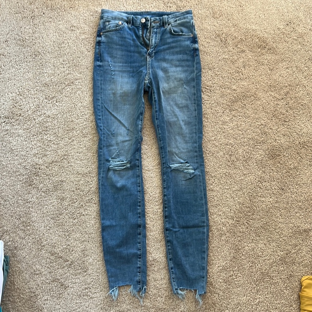 Light blue jeans with rips in the knees